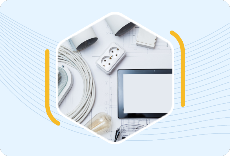 building plan covered in eletrical parts including a cable, outlet, lightbulb and a tablet.